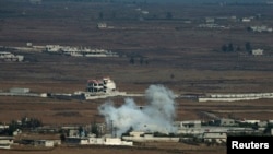Smoke rises following an explosion on the Syrian side near the Quneitra border crossing, Aug. 29, 2014. 