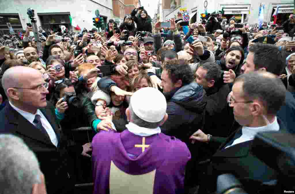 Pope Francis greets the crowds after conducting a mass in Saint Anna church inside the Vatican, March 17, 2013.
