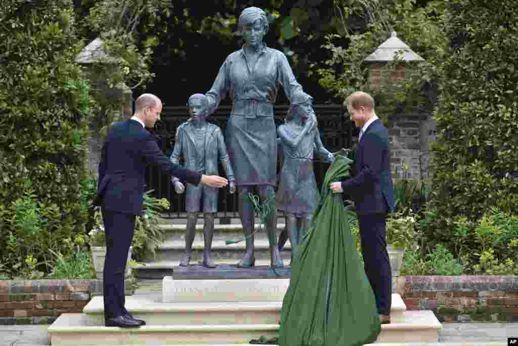 Britain&#39;s Prince William and Prince Harry unveil a statue of their mother Princess Diana, on what would have been her 60th birthday, in the Sunken Garden at Kensington Palace, London.