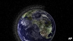 This handout illustration image created by Australia's Electro Optic Systems (EOS) aerospace company shows a view of the Earth from geostationary height depicting swarms of space debris in Low Earth Orbit (LEO), 20 Jul 2010