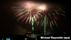  The Independence Day fireworks are set off in the fog and rain above the Washington DC skyline, with the Lincoln Memorial seen beneath; as seen from Arlington, Virginia, USA, 04 July 2016. 