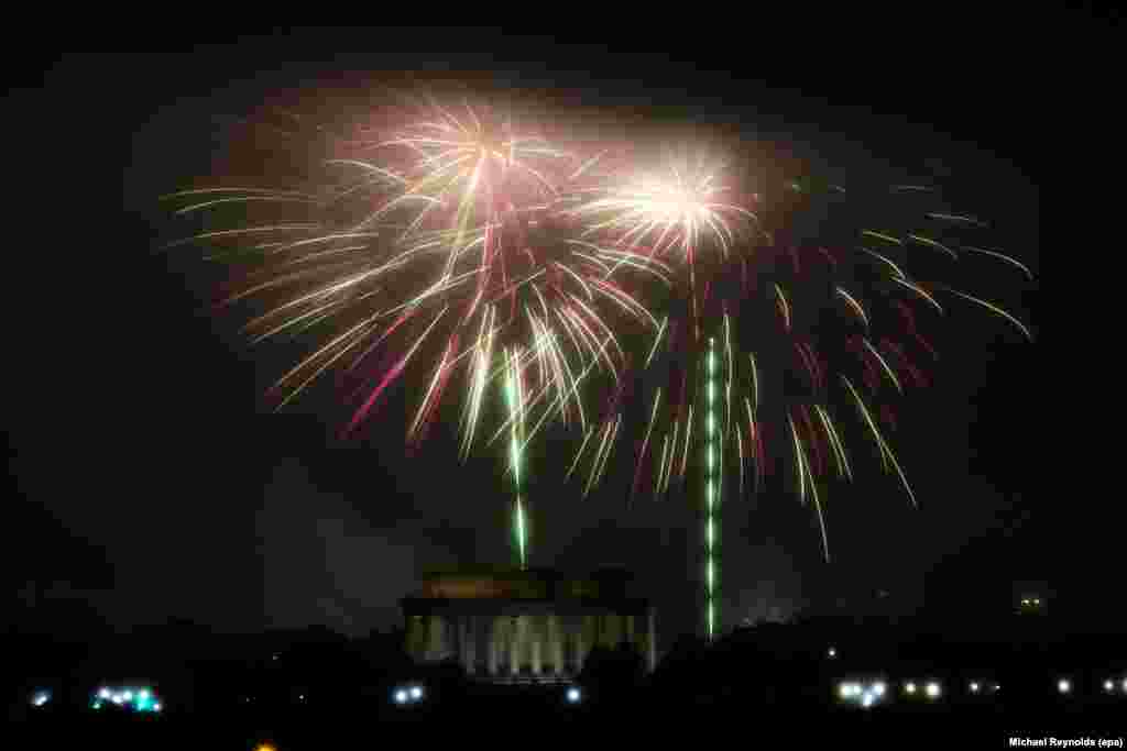 The Independence Day fireworks are set off above the Washington DC skyline, with the Lincoln Memorial seen beneath; as seen from Arlington, Virginia, USA, 04 July 2016.