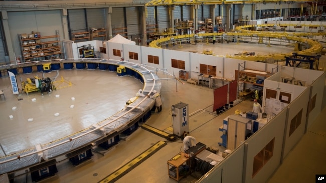 A poloidial field coil assembly line is pictured at the ITER (the International Thermonuclear Experimental Reactor) in Saint-Paul-Lez-Durance, southern France, Tuesday, July 28, 2020. The project aims to replicate the energy of the sun to create nuclear fusion reactions as a way to produce power. (AP Photo/Daniel Cole)
