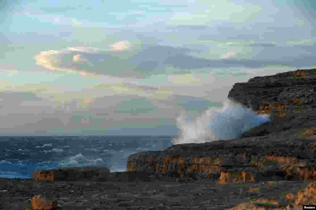 Waves break against the cliffs where the famous natural structure, known as the Azure Window, collapsed after the Maltese islands were hit by rough seas and stormy weather, at Dwejra on the island of Gozo, Malta.