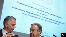 Swiss Foreign Minister Didier Burkhalter (L) gestures next to U.N. High Commissioner Antonio Guterres for refugees at the opening of a two-day International conference on the Afghan refugee situation on May 2, 2012 in Geneva.