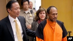 FILE - Juan Francisco Lopez-Sanchez (R), charged with the murder of 32-year-old Kate Steinle, is seen being escorted into a courtroom at the Hall of Justice in San Francisco, California, July 7, 2015.