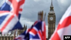 National flags flutter near the The Elizabeth Tower, commonly referred to as Big Ben, in central London, June 9, 2017. 