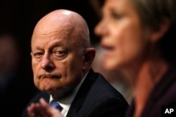 Former National Intelligence Director James Clapper listens as former acting Attorney General Sally Yates testifies on Capitol Hill in Washington, May 8, 2017
