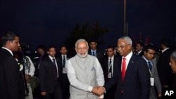 FILE - Maldives' new President Ibrahim Mohamed Solih, center right, receives Indian Prime Minister Narendra Modi at the President's office in Male, Maldives, Nov. 17, 2018. 