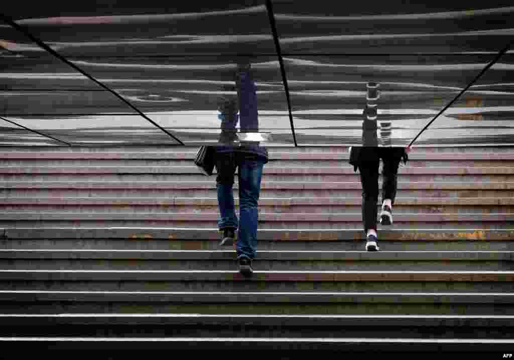 People walk out of an underground crossing in Moscow , Russia.