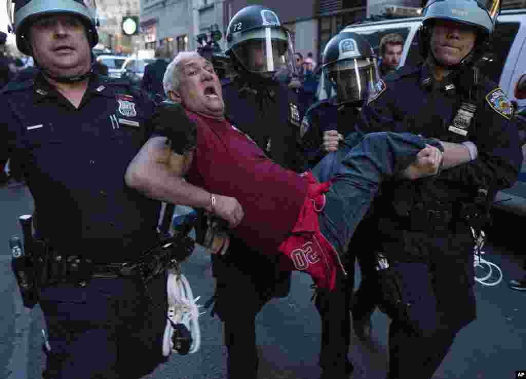 A man is carried by police officers as arrests are made at a protest at New York City&#39;s Union Square over the death of Freddie Gray, a Baltimore man who died while in police custody, April 29, 2015.