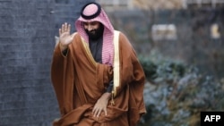 FILE - Saudi Arabia's Crown Prince Mohammed bin Salman waves as he arrives for talks at 10 Downing Street, in central London, Britain, March 7, 2018. In a U.S. television interview, Prince Mohammed likened Iran's Supreme Leader Ali Khamenei to Adolf Hitler, saying that he "wants to create his own project in the Middle East."