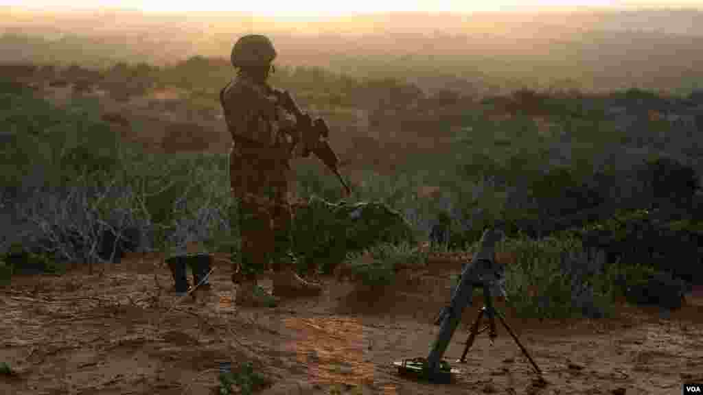 Un soldat en garde, débout, au sommet de la colline au-delà de la ville de Baraawe qui est sous le contrôle d&rsquo;Al Shabab dans la région du Bas-Shabelle en Somalie, le 5 octobre. AMISOM Photo / Tobin Jones 