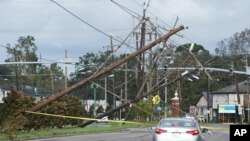 This is captionTraffic diverts around downed power lines Monday, Aug. 30, 2021, in Metairie, La. A fearsome Hurricane Ida has left scores of coastal Louisiana residents trapped by floodwaters and pleading to be rescued, while making a shambles of the electrical grid acr