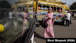 In this 2016 photo taken in Dakar, Senegal, a woman appears to be beside herself. But it's just her reflection. However, "to be beside yourself" is a common English expression. 