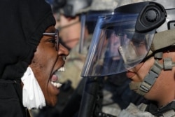 Protesters and National Guardsmen face off on East Lake Street, Friday, May 29, 2020, in St. Paul, Minn. Protests continued following the death of George Floyd, who died after being restrained by Minneapolis police officers on Memorial Day. (AP Photo/John