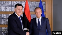 Libyan Prime Minister Fayez al-Sarraj poses with European Council President Donald Tusk in Brussels, Belgium, May 13, 2019. 