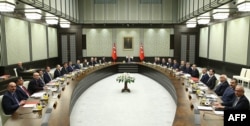 A handout made available by the Presidential Palace Press Office on Jan. 19, 2015 shows Turkey's President Recep Tayyip Erdogan (Rear) presiding over the Cabinet meeting at the presidential palace in Ankara, Jan. 19, 2015.