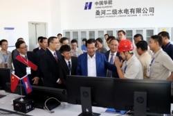 FILE - Cambodia's Prime Minister Hun Sen (C) inaugurates the 400 megawatt Lower Sesan 2 hydropower plant during a ceremony in Stung Treng province on December 17, 2018.