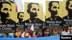 FILE - Protesters display placards with images of national revolutionary hero Apolinario Mabini as they march to the Chinese consulate office in Makati, Metro Manila, June 12, 2014.