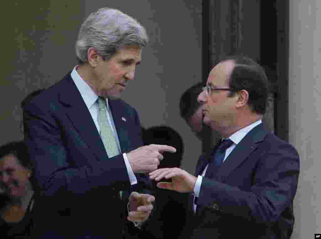 .S. Secretary of State John Kerry, left, is accompanied by France's President Francois Hollande after their meeting at the Elysee Palace, in Paris, Wednesday, Feb. 27, 2013. 