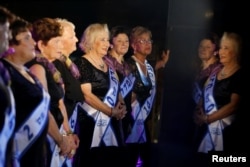 Contestants are reflected in a marble column during the annual Holocaust survivors' beauty pageant in the Israeli city of Haifa, Oct. 30, 2016.