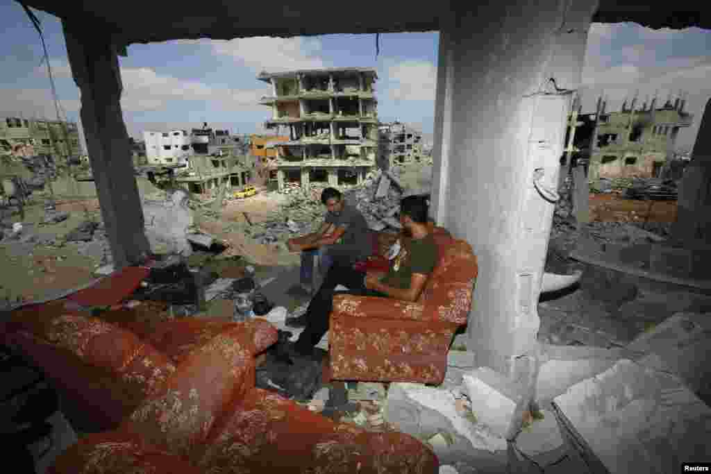 Palestinians return to the remains of their house after the ceasefire was declared, in the east of Gaza City. Aug. 27, 2014.
