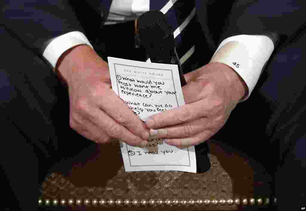 U.S. President Donald Trump holds notes during a listening session with high school students and teachers in the State Dining Room of the White House in Washington, Feb. 21, 2018. Trump heard the stories of students and parents affected by school shootings, following last week&#39;s deadly shooting in Florida.