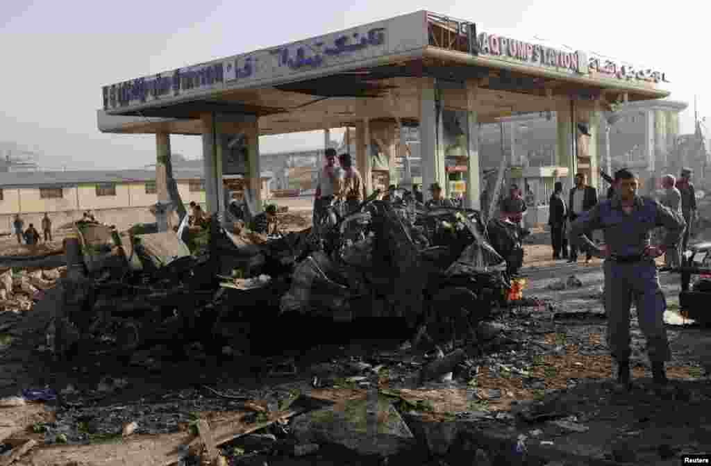 Afghan security personnel investigate at the site of a suicide attack, Kabul, Afghanistan, September 18, 2012.