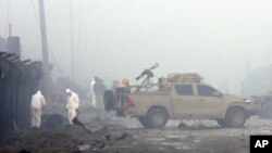 Security forces inspect the site of a suicide bomb attack in Kabul, Afghanistan, Nov. 29, 2018. Taliban insurgents staged a deadly coordinated attack targeting a British security firm in the Afghan capital Wednesday.