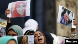 FILE - Female relatives of women prisoners shout slogans against the military and the interior ministry at an event called "Release Our Girls" during International Women's Day in front of the Press Syndicate in Cairo, Egypt.