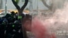 Polisi anti huru-hara menembakkan gas air mata ke arah demonstran anti-pemerintah di Bangkok, Thailand, Minggu, 18 Juli 2021.