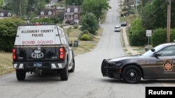 Law enforcement members guard the perimeter of the home of Trump shooting suspect