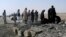 FILE - Pakistani officials investigate the site of bombing at Chaman, border post on the Pakistan Afghanistan border in Pakistan, Nov. 21, 2016.