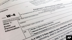 FILE - A W-4 form on Feb. 5, 2020, in New York. The IRS will receive tens of millions of filings electronically and through paper forms.