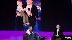 Elon Musk and TED Head Curator Chris Anderson talk in Vancouver in front of a picture of Musk’s son “X” on screen. (Photo courtesy TED)