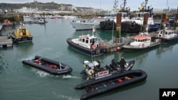 FILE: Inflatable dinghies, used by migrants to cross the English Channel are brought to port, April 14, 2022, in the marina at Dover. Britain will send migrants and asylum seekers thousands of miles away to Rwanda under a controversial deal as London tries to curb crossings.