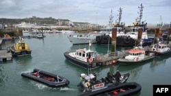 FILE: Inflatable dinghies, used by migrants to cross the English Channel are brought to port in the marina at Dover. 4.14.2022