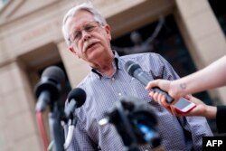 Carl Mueller, the father of Kayla Mueller, an American human rights activist slain by Islamic State militants, speaks to reporters outside the Albert V. Bryan Federal Courthouse, in Alexandria, Virginia, April 14, 2022.