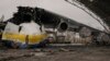 A Ukrainian serviceman walks by the Antonov An-225 Mriya aircraft, destroyed by Russian strikes, at the Antonov airport in Hostomel, Ukraine, April 2, 2022.