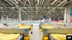 In this photo released by China's Xinhua News Agency, a makeshift hospital for COVID-19 patients is seen at the National Exhibition and Convention Center in Shanghai, April 12, 2022.