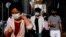 People wearing face masks walk through Wan Chai during the coronavirus disease (COVID-19) pandemic in Hong Kong, China, Apr. 14, 2022. 