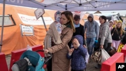 Ukrajinske izbjeglice na graničnom prelazu sa Poljskom. (Foto: AP/Sergei Grits)