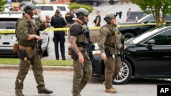 Authorities prepare outside Columbiana Centre mall in Columbia, S.C., following a shooting, April 16, 2022.