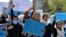 FILE - Afghan women and girls shout slogans demanding the reopening of high schools for girls during a demonstration in front of the Ministry of Education in Kabul, March 26, 2022.
