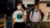 People wearing face masks walk through Wan Chai during the COVID-19 pandemic in Hong Kong, April 14, 2022. 