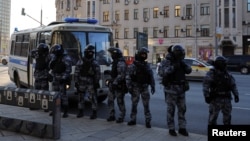 FILE - Riot police stand guard as people prepare to take part in an antiwar protest against the Russian invasion of Ukraine on Feb. 27, 2022. 