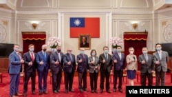 Taiwan President Tsai Ing-wen is pictured with six U.S. lawmakers and other U.S. delegation members at the presidential office in Taipei, Taiwan, in this handout picture released April 15, 2022.
