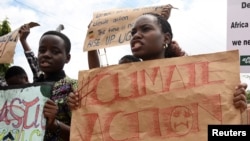 FILE - Leah Namugerwa (L) and Hilda Flavia Nakabuye coordinator of 'Fridays for Future' lead Ugandan students in taking part in the global 'School Strike for Climate' in Kampala, Uganda May 24, 2019. Picture taken May 24, 2019.
