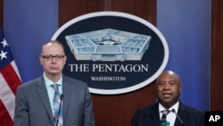Dr. John F. Huth, left, DIA Defense Intelligence Officer for Space and Counterspace and Kevin Ryder, DIA Senior Defense Intelligence Analyst for Space and Counterspace, participate in a briefing at the Pentagon in Washington, Tuesday, April 12, 2022.